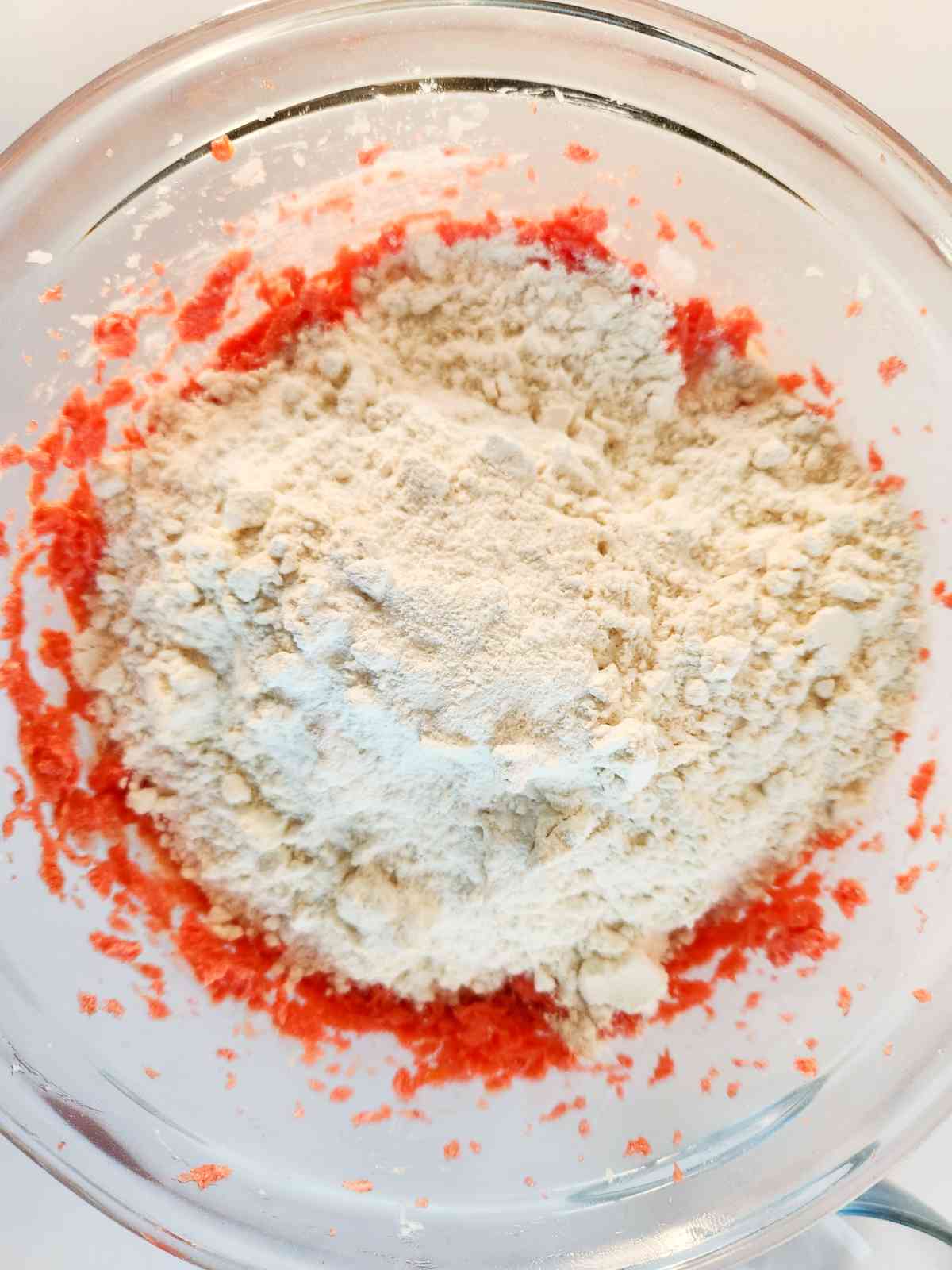 Adding dry ingredients to pink batter.
