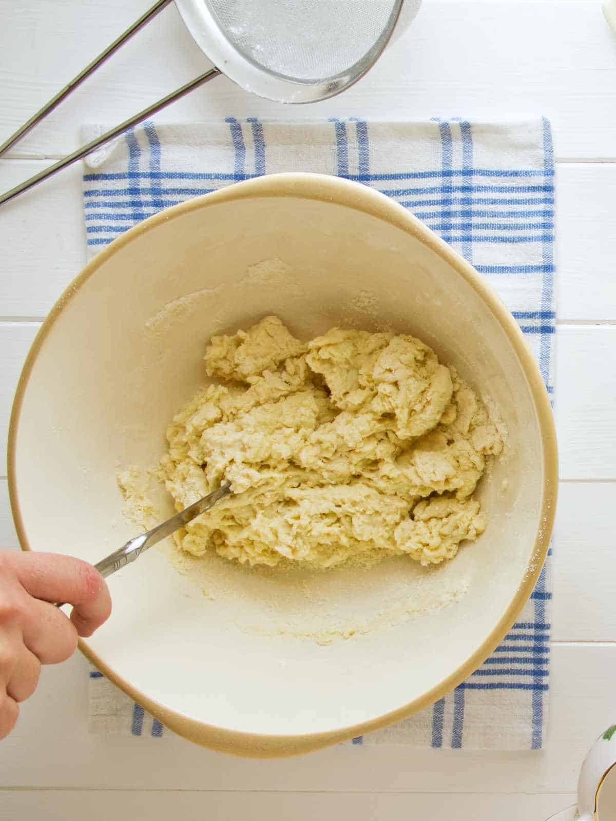 mixing dough in a bowl.