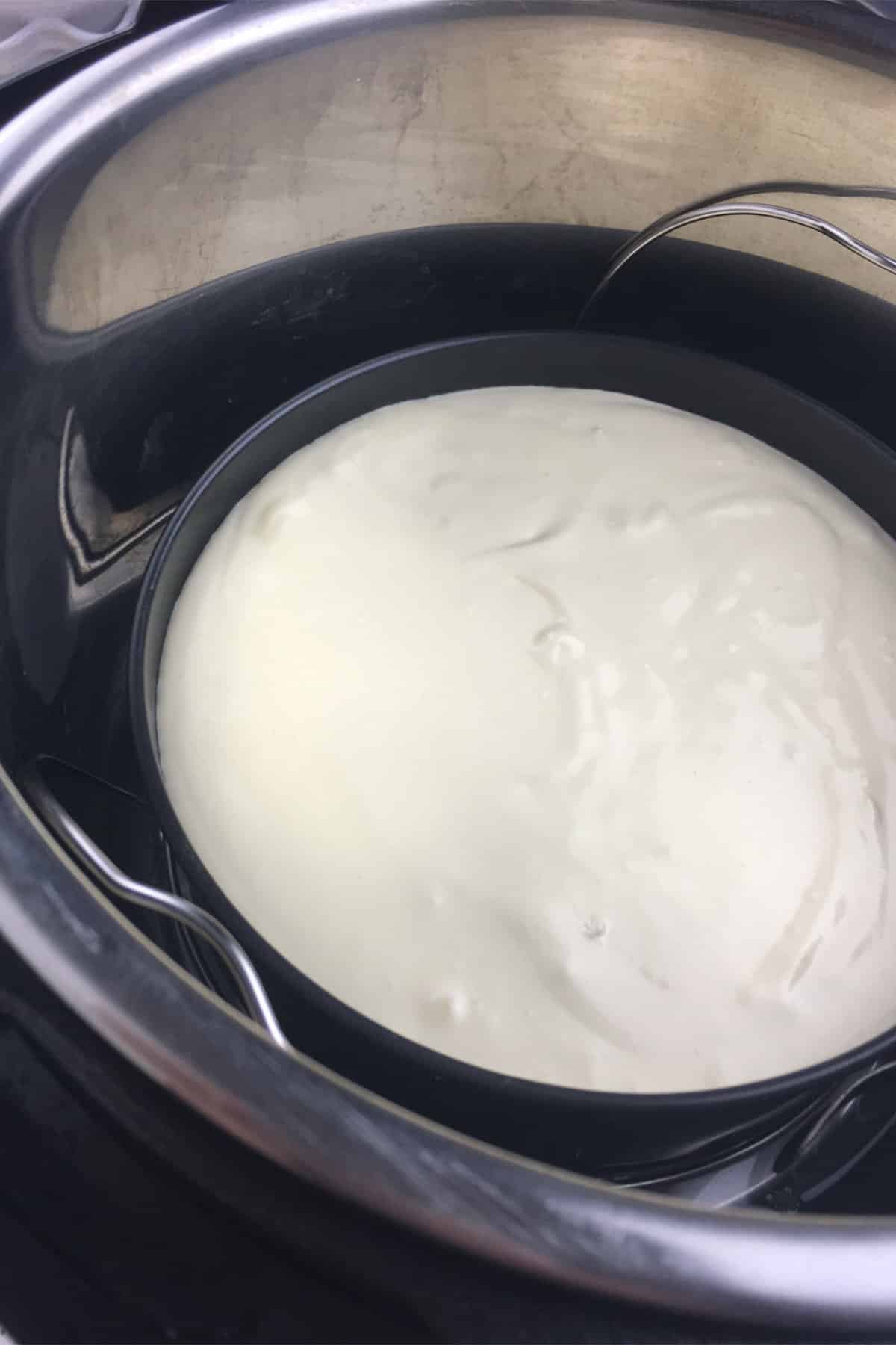 Small Instant pot springform pan filled with keto cheesecake batter, placed in an Instant Pot.