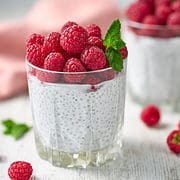 raspberry topped glass of chia pudding.
