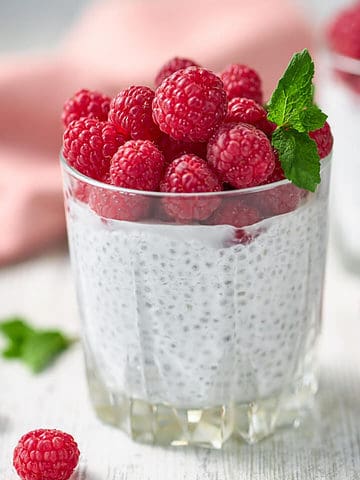 raspberry topped glass of chia pudding.