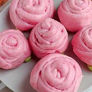 Pink steamed mantou buns shaped like rose buds.