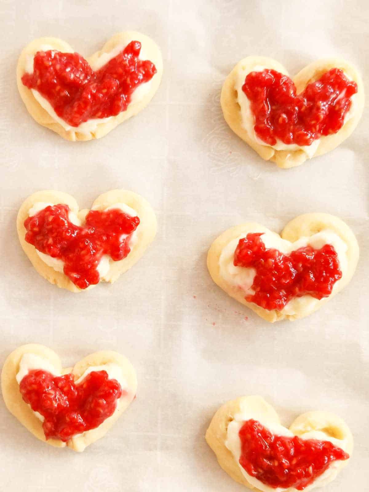 heart shaped danish topped with raspberry.