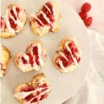 Baked crescent roll heart with icing drizzled on top.