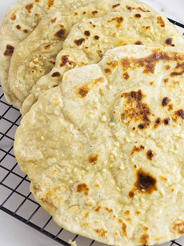 hot naan on a cooling rack.