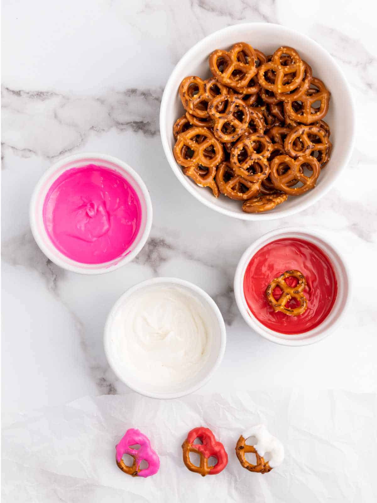 Melted pink, red, and white candy with mini pretzel knots.