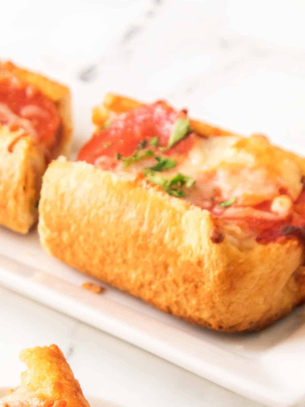 french bread pizza in air fryer on a plate.