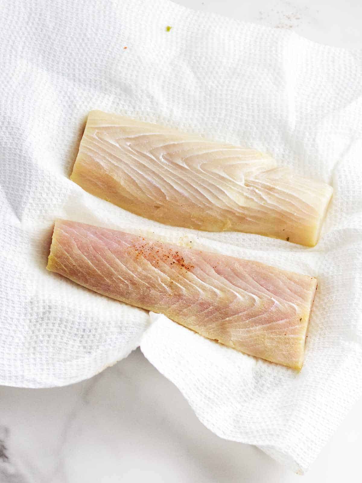 fish fillets on paper towels to blot dry.
