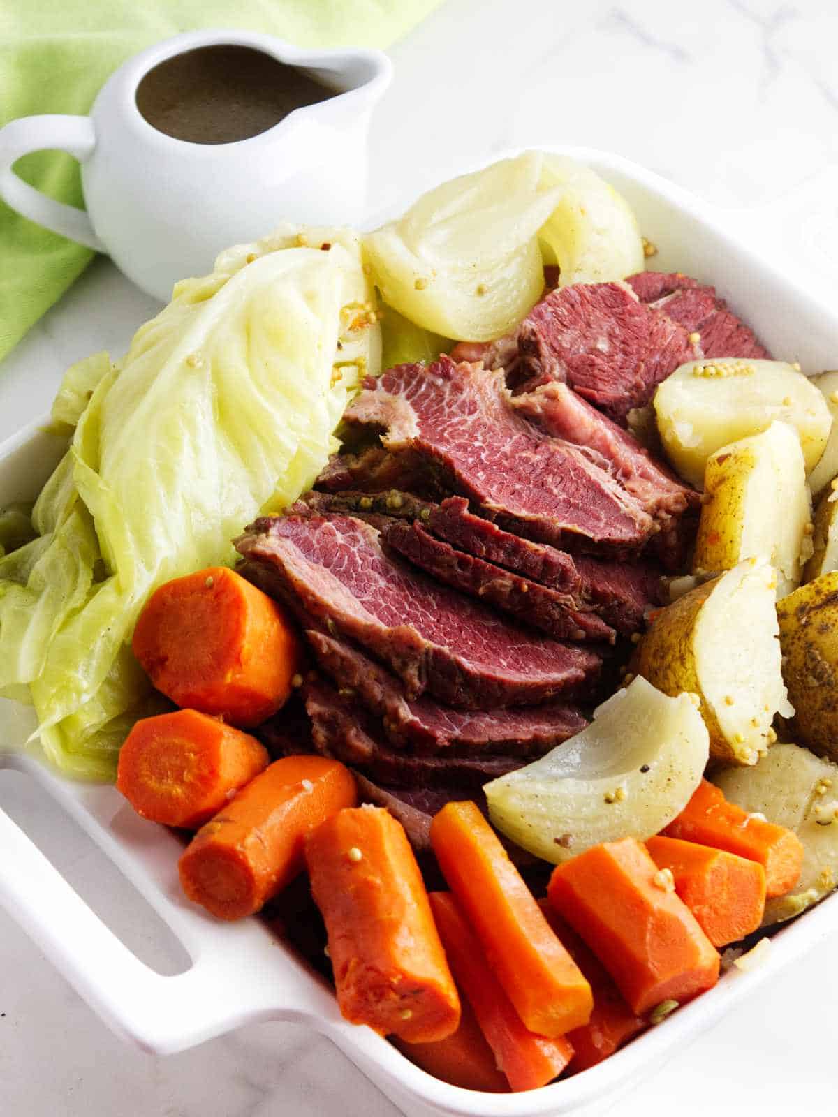 serving bowl filled with cooked corned beef and cabbage.