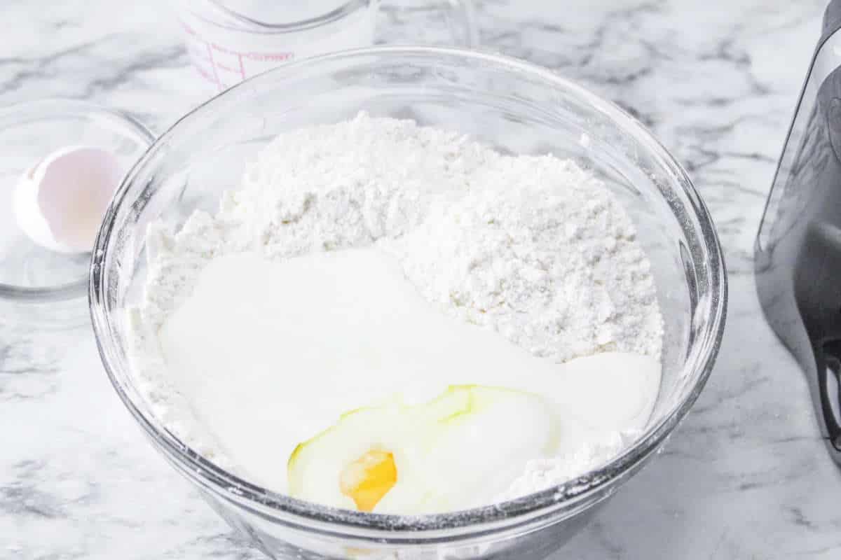 buttermilk and egg added to dry ingredients in a large mixing bowl.
