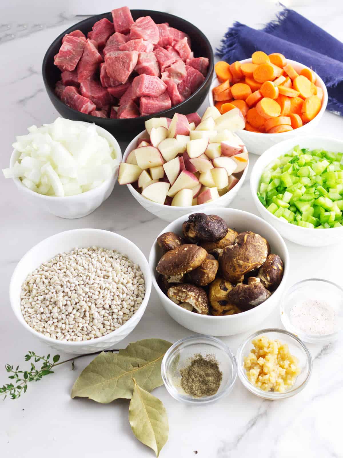 chuck beef cubes, carrot chunks diced onion, chunked red potatoes, diced celery, portobello mushrooms, bay leaves read to cook with.