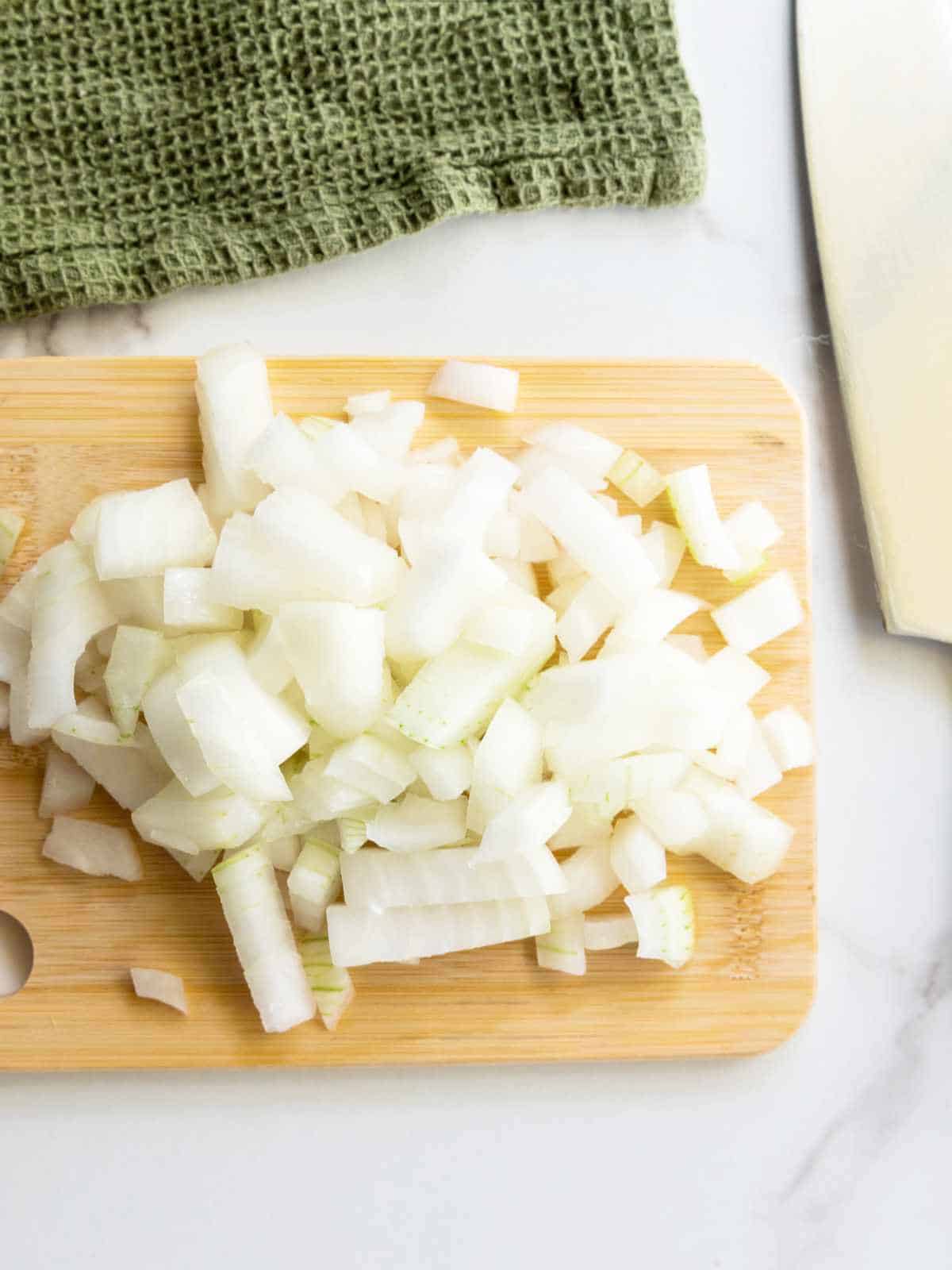 diced onion on a chopping block.