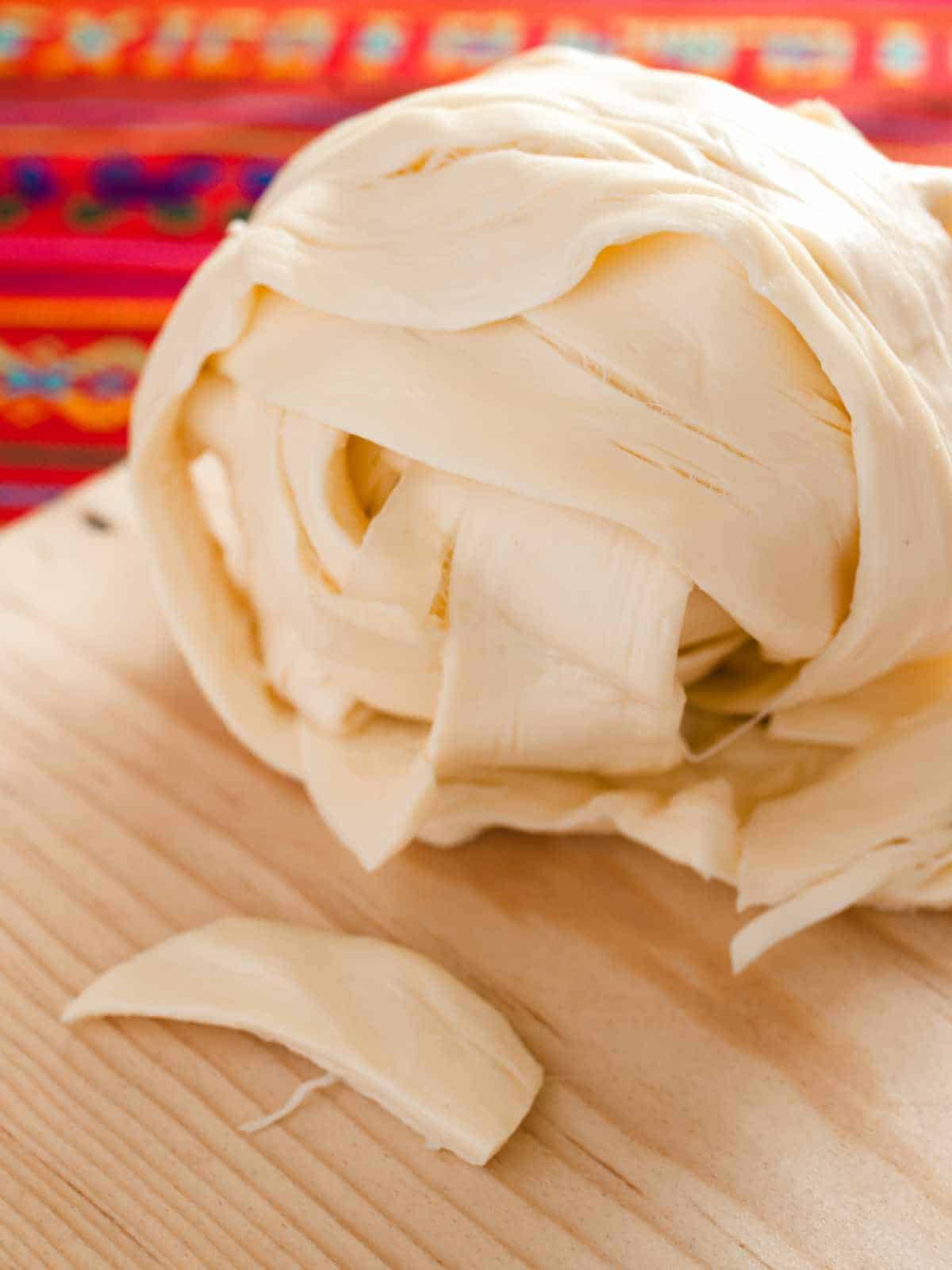 Oaxaca cheese on a cutting board.