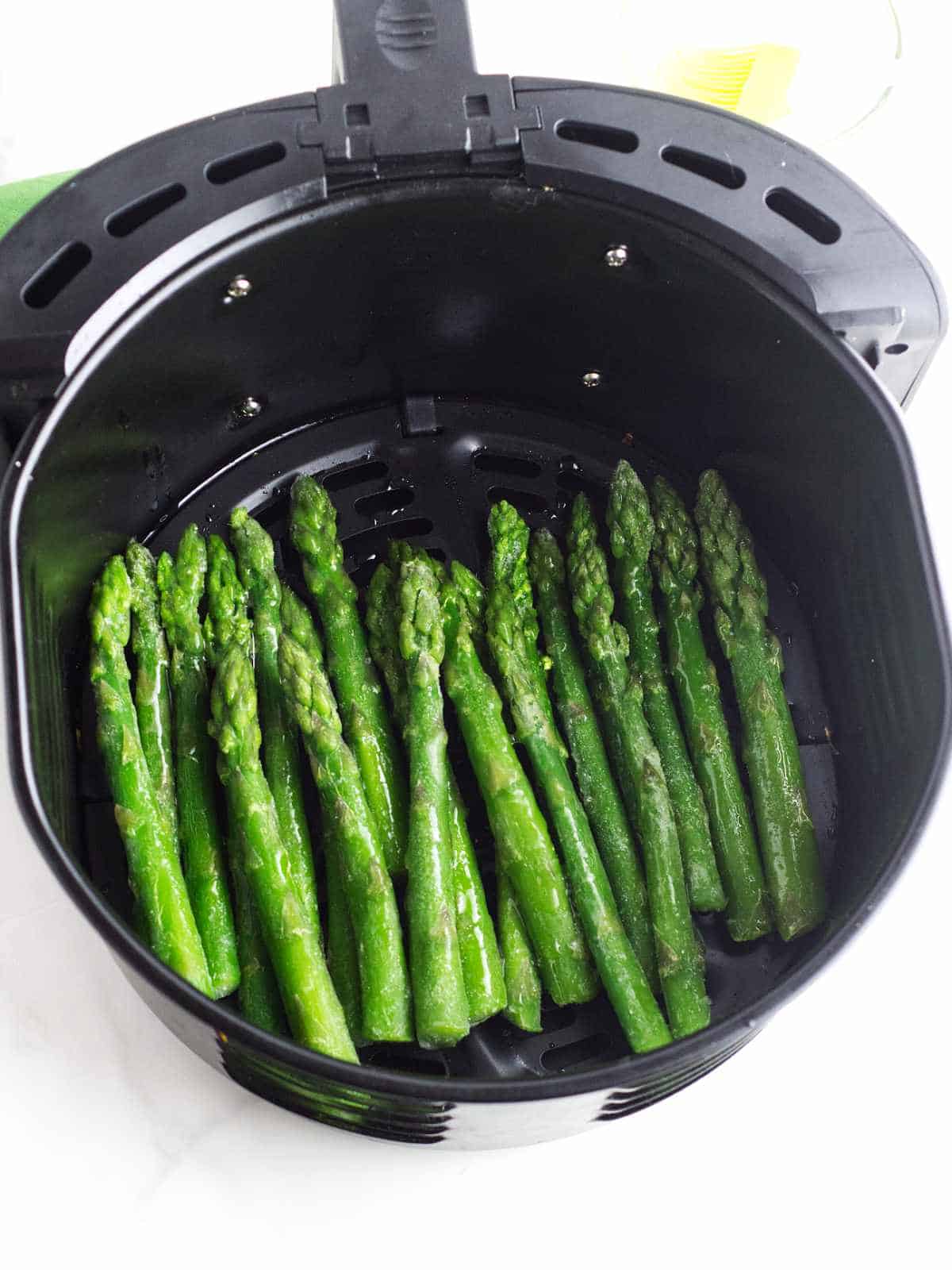 Frozen spears of asparagus brushed with olive oil and seasoned with salt and pepper.