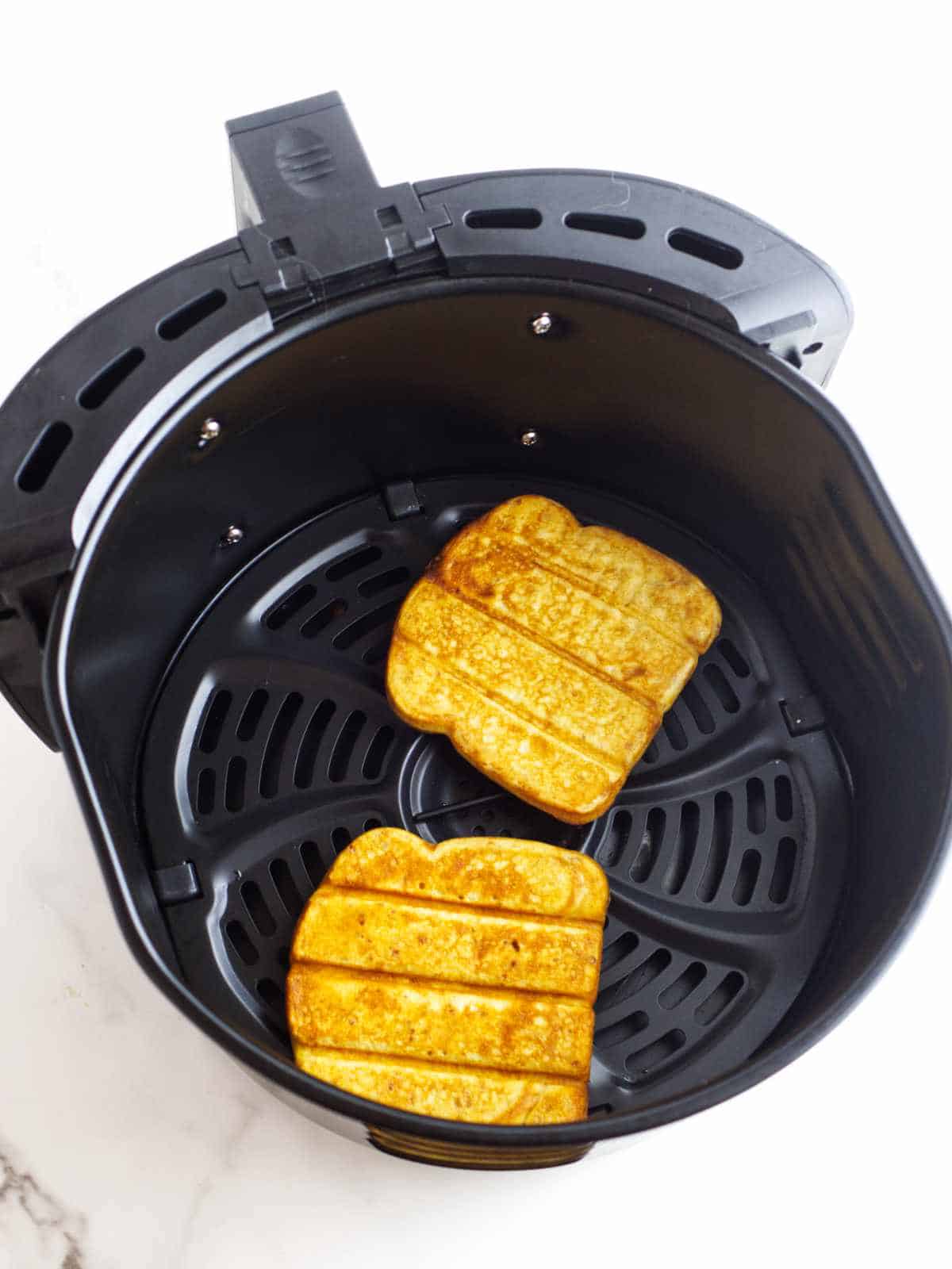 cooked Eggo slices in an air fryer.