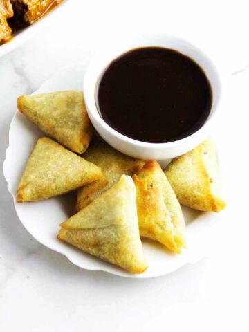 air fried samosa appetizers with dip.