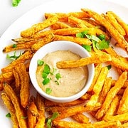 Golden Frites with dipping sauce on a plate.