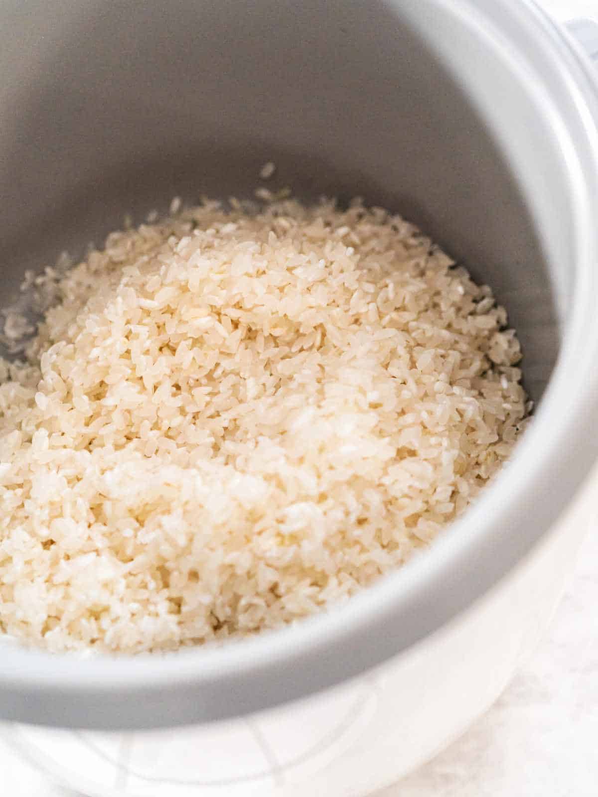 rinsed rice in a rice cooker.