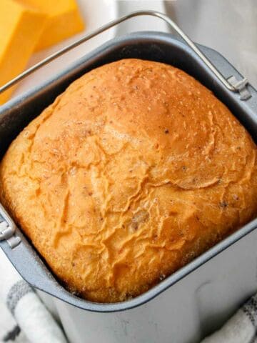 golden brown bread machine cheese bread in the baking pan.