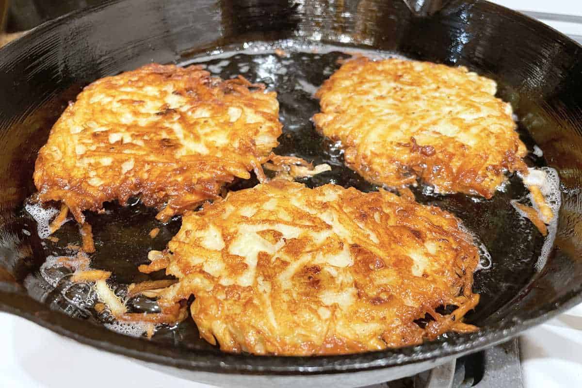 celery root latkes, low carb latkes, with sour cream on a serving platter.