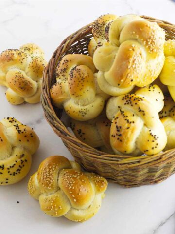 basket of seeded challah rolls.