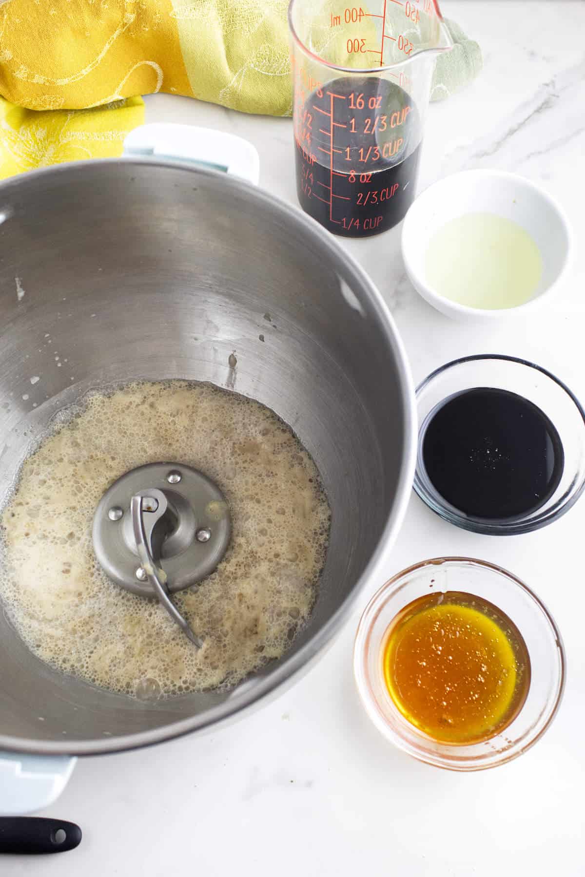Yeast mixture with molasses, honey, oil, and coffee for brown bread rolls.