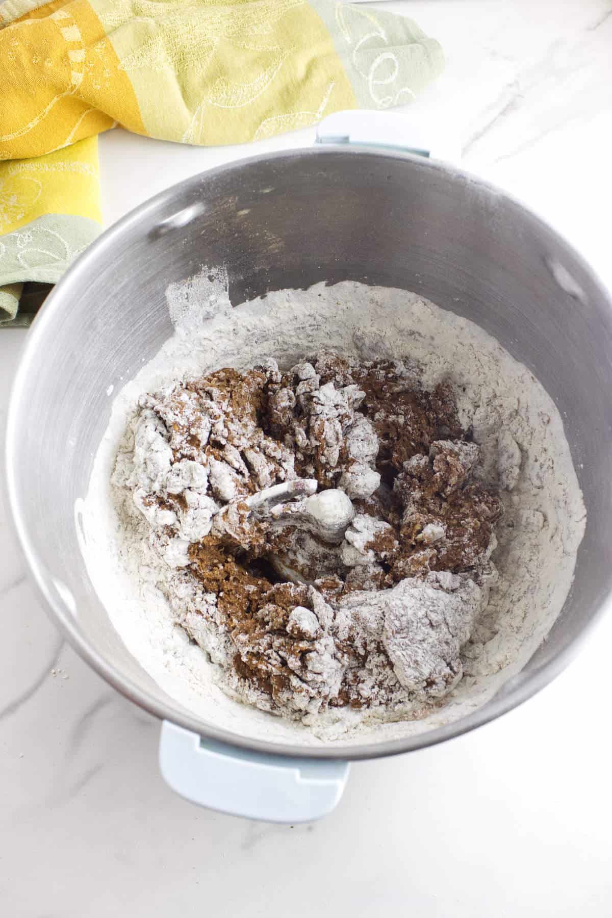 Shaggy dough for Cheesecake Factory brown bread rolls in a mixing bowl.