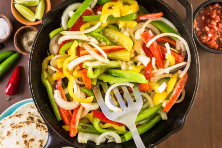 Skillet of sauteed bell peppers and onions for steak fajitas.