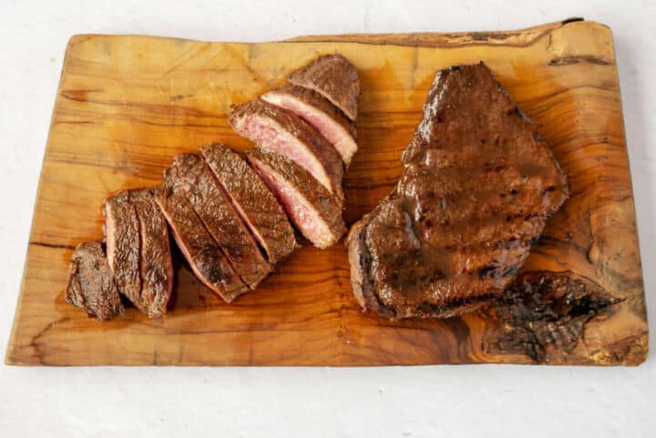 Grilled steak on a wooden board for Chili's Steak Fajitas.