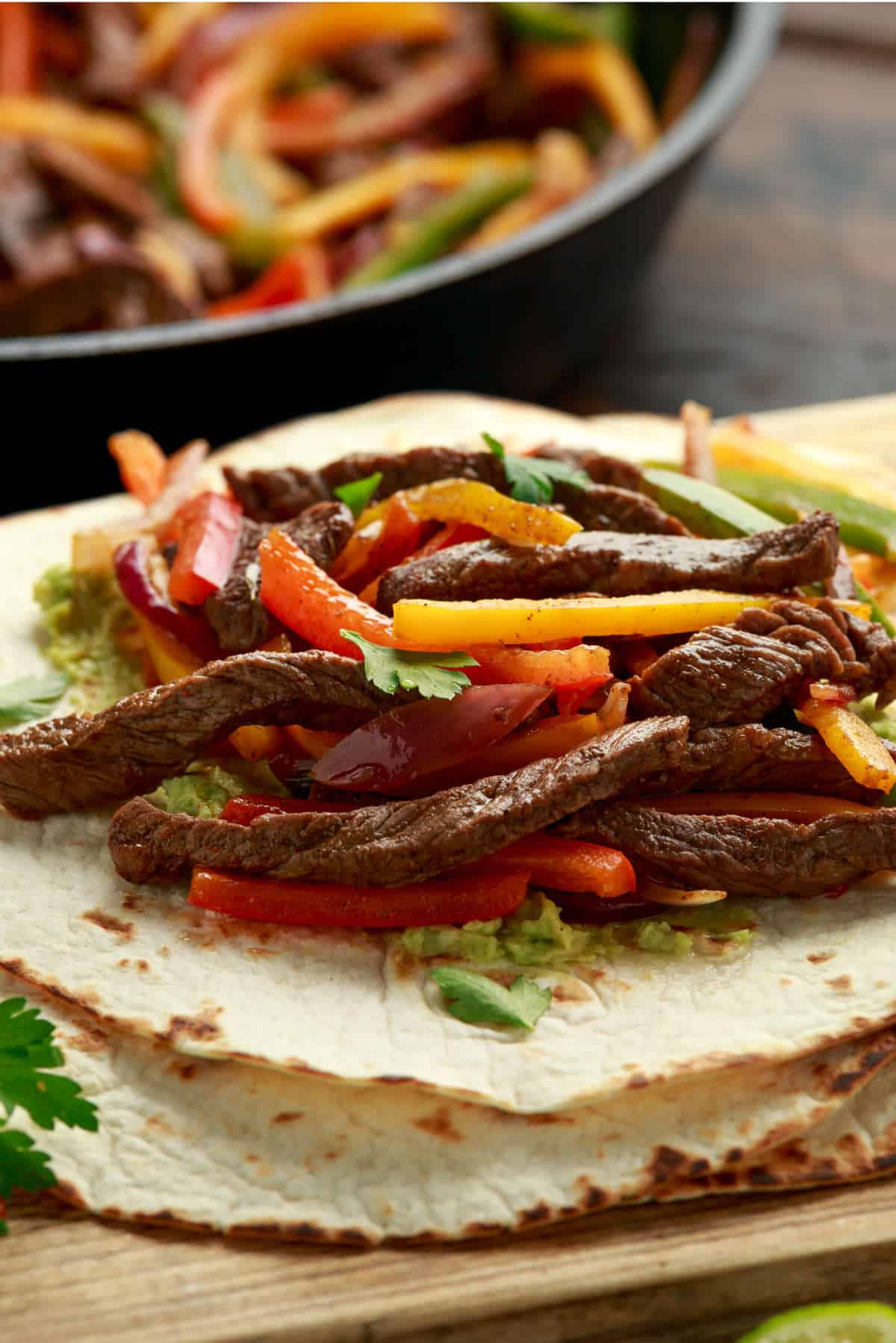 Chili's steak fajitas copycat with sliced steak, peppers, onions, and tortillas.