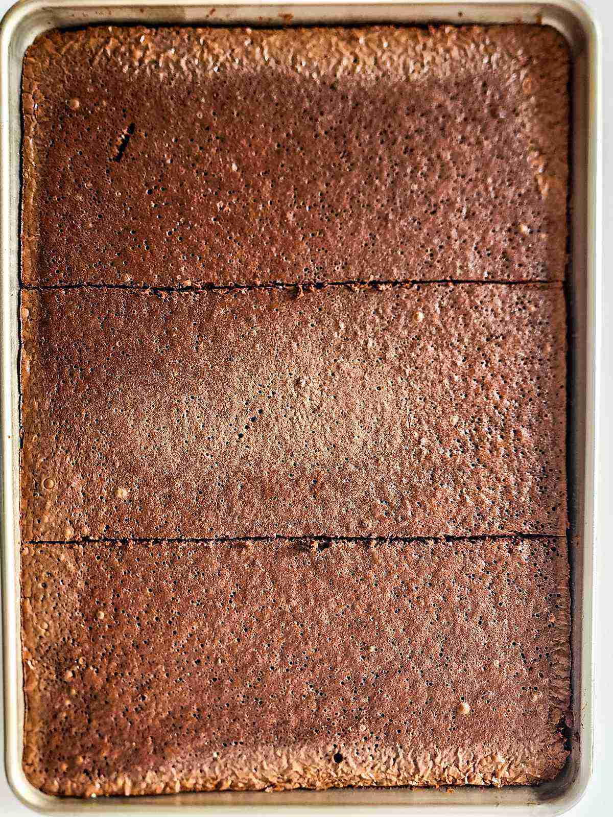 sheet pan with thin baked brownie.