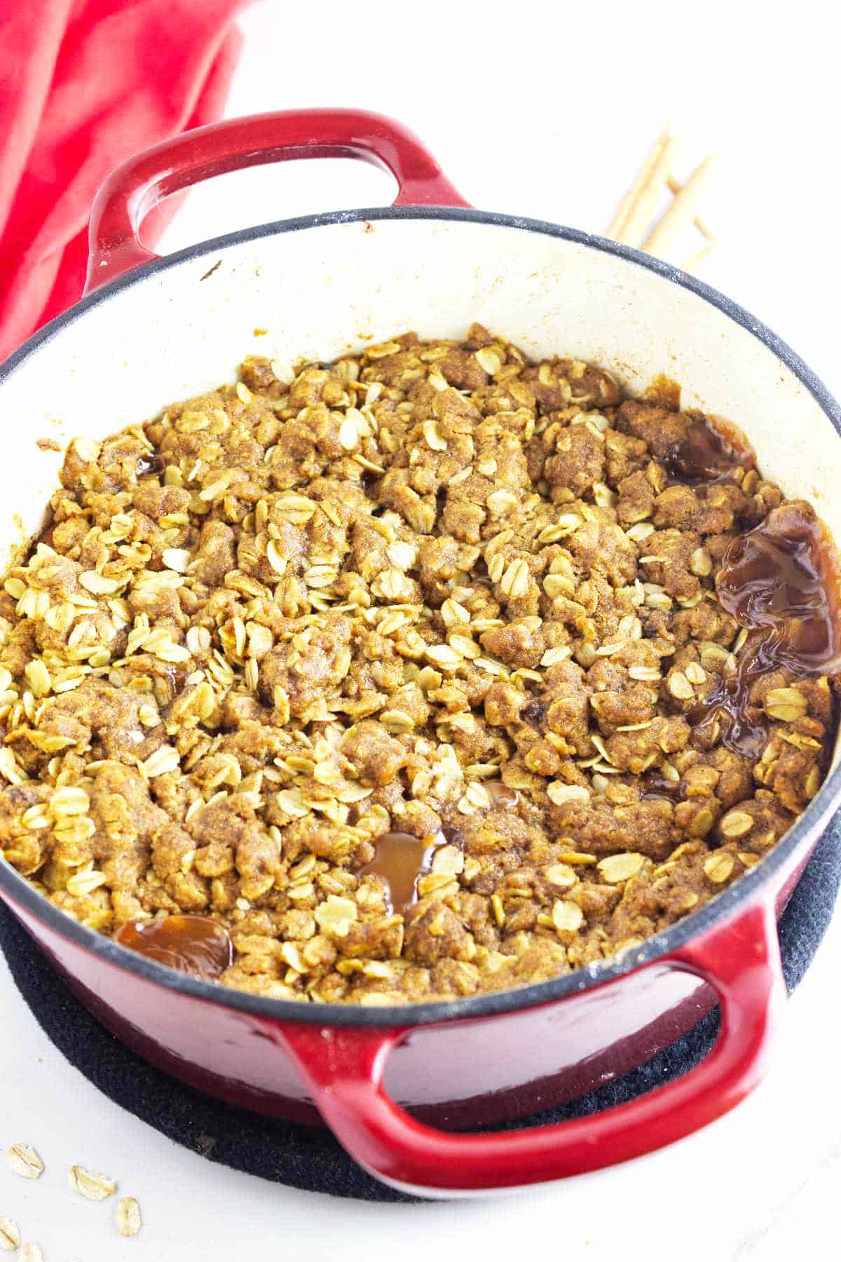 dutch oven apple crisp with a spoon.