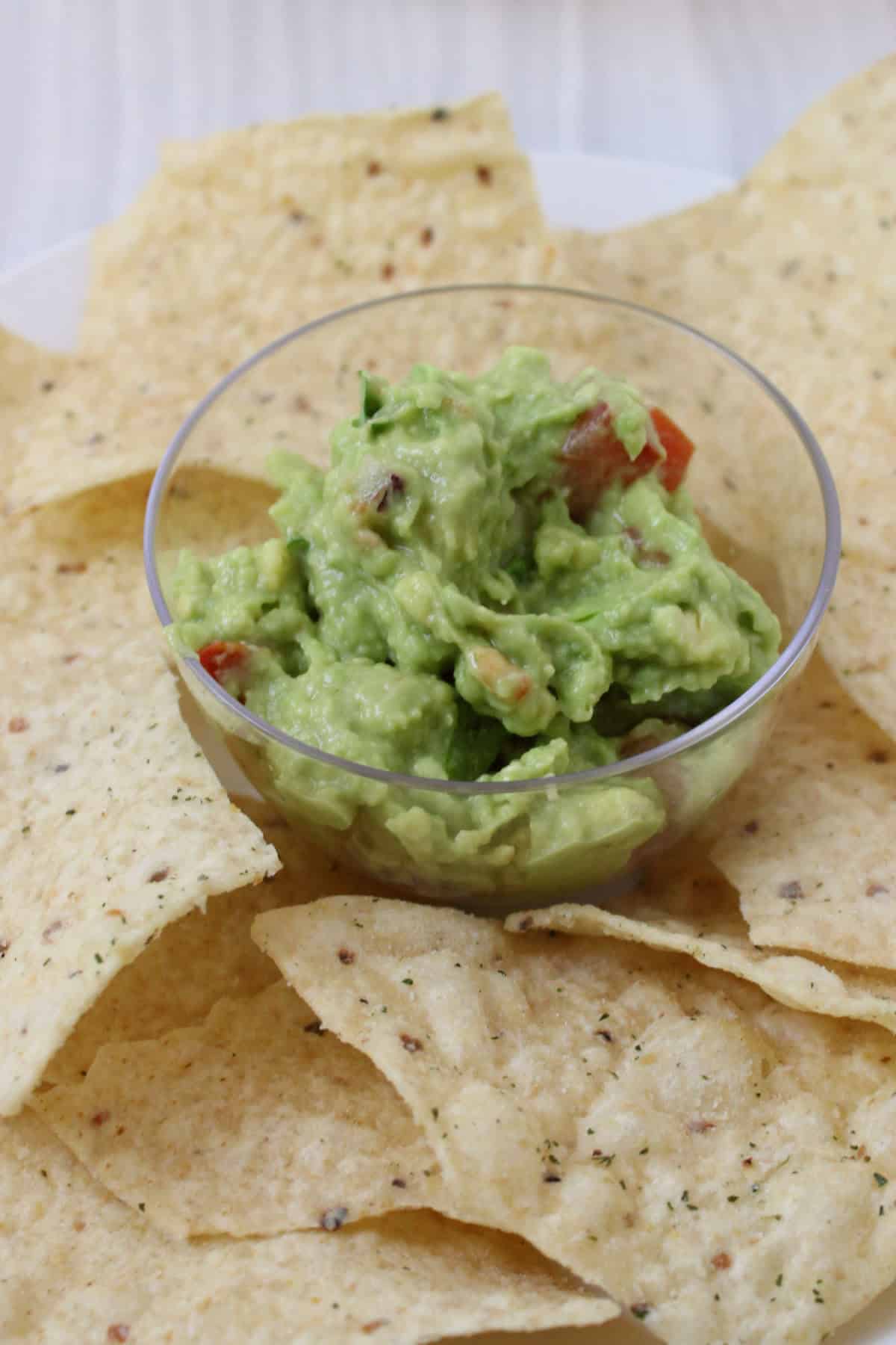 Bowl of guacamole served with tortilla chips for dipping.