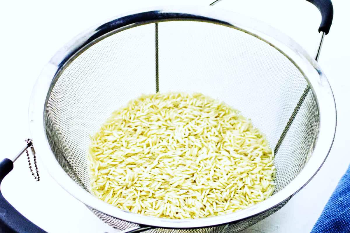 Rinsed basmati rice draining in a colander before cooking in the Instant Pot.