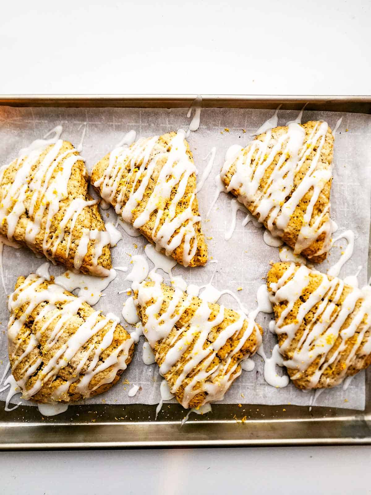 icing drizzled over baked wedge shaped scones.