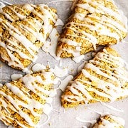 icing drizzled over baked wedge shaped lemon poppy seed scones.