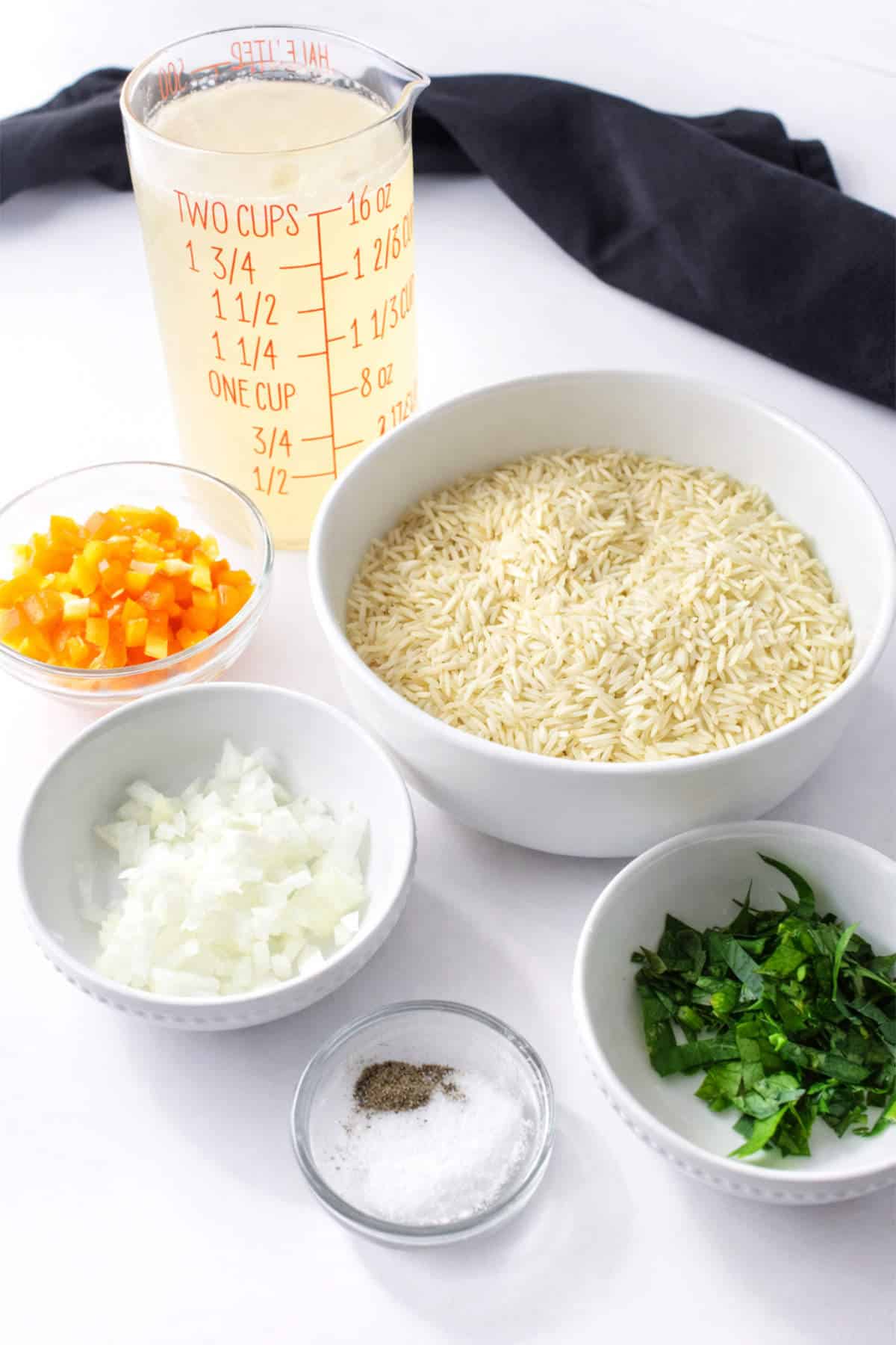 Ingredients for Longhorn Steakhouse rice pilaf including rice, broth, onion, and parsley.