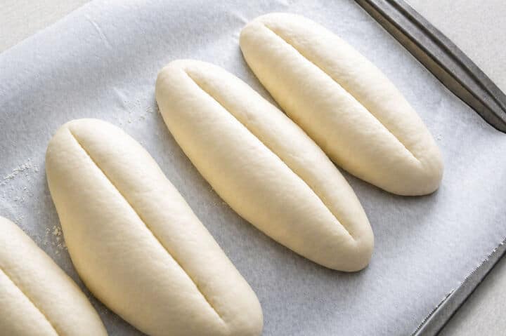 Scored bolillo dough ready to bake with steam.