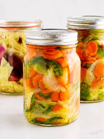 Mexican pickled carrots next to guacamole topped tacos.