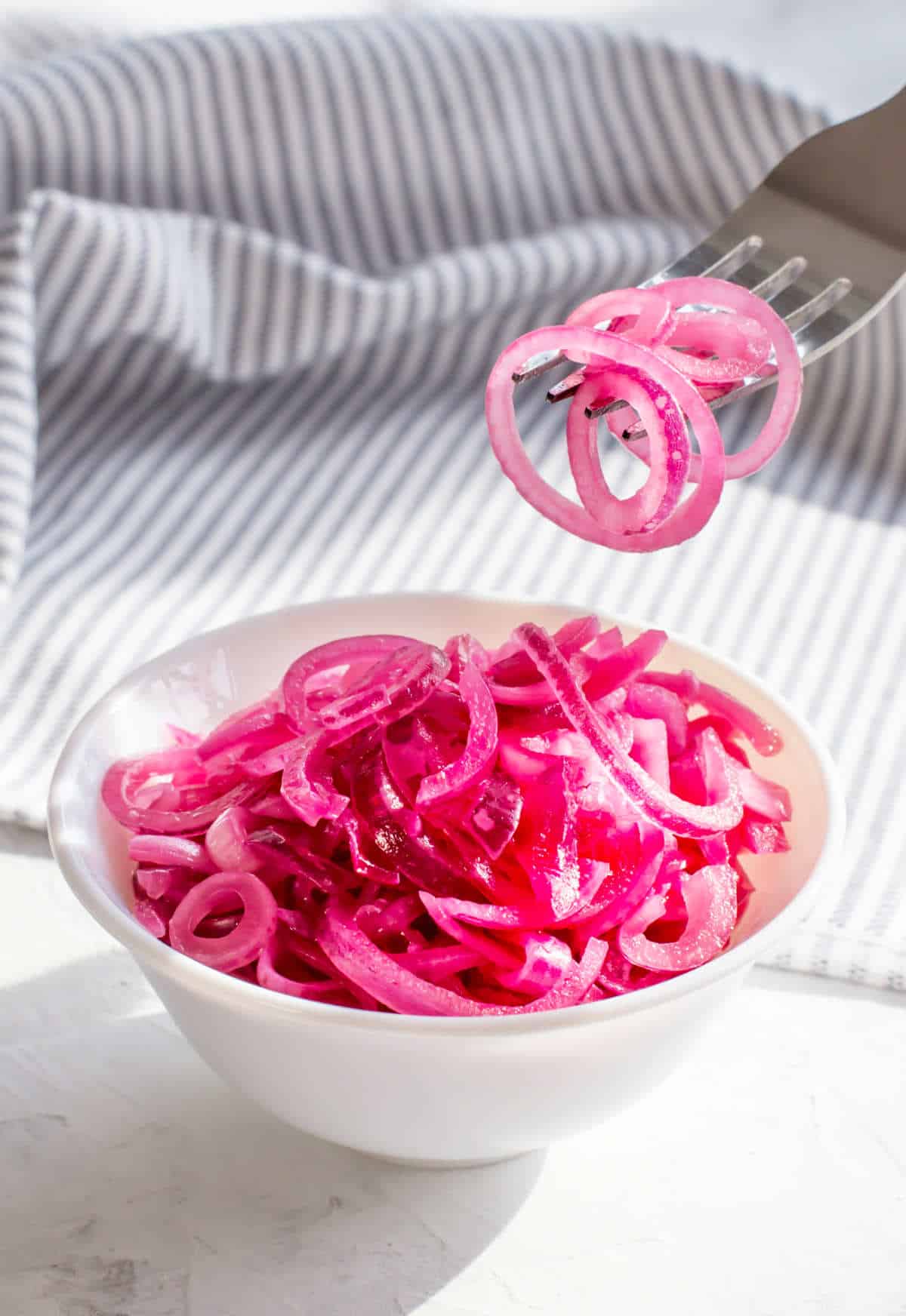 Mexican pickled red onions in a bowl with a vivid magenta color.