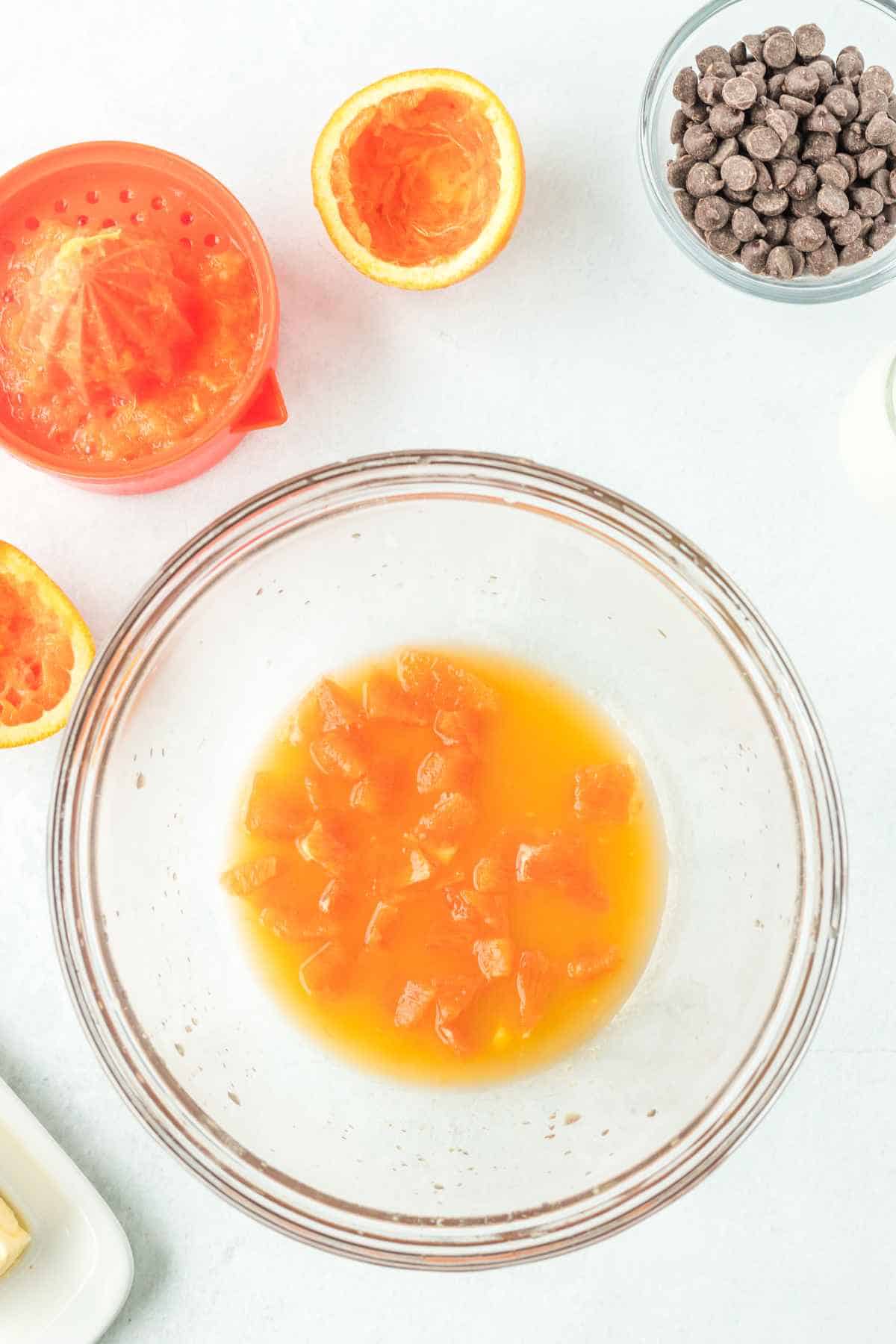 bowl of orange juice and diced oranges.