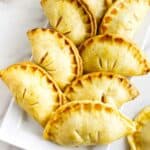 golden brown peach hand pies on a serving platter.