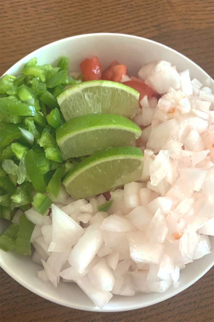 Chopped tomatoes, onion, jalapeno, and cilantro prepared for pico de gallo.