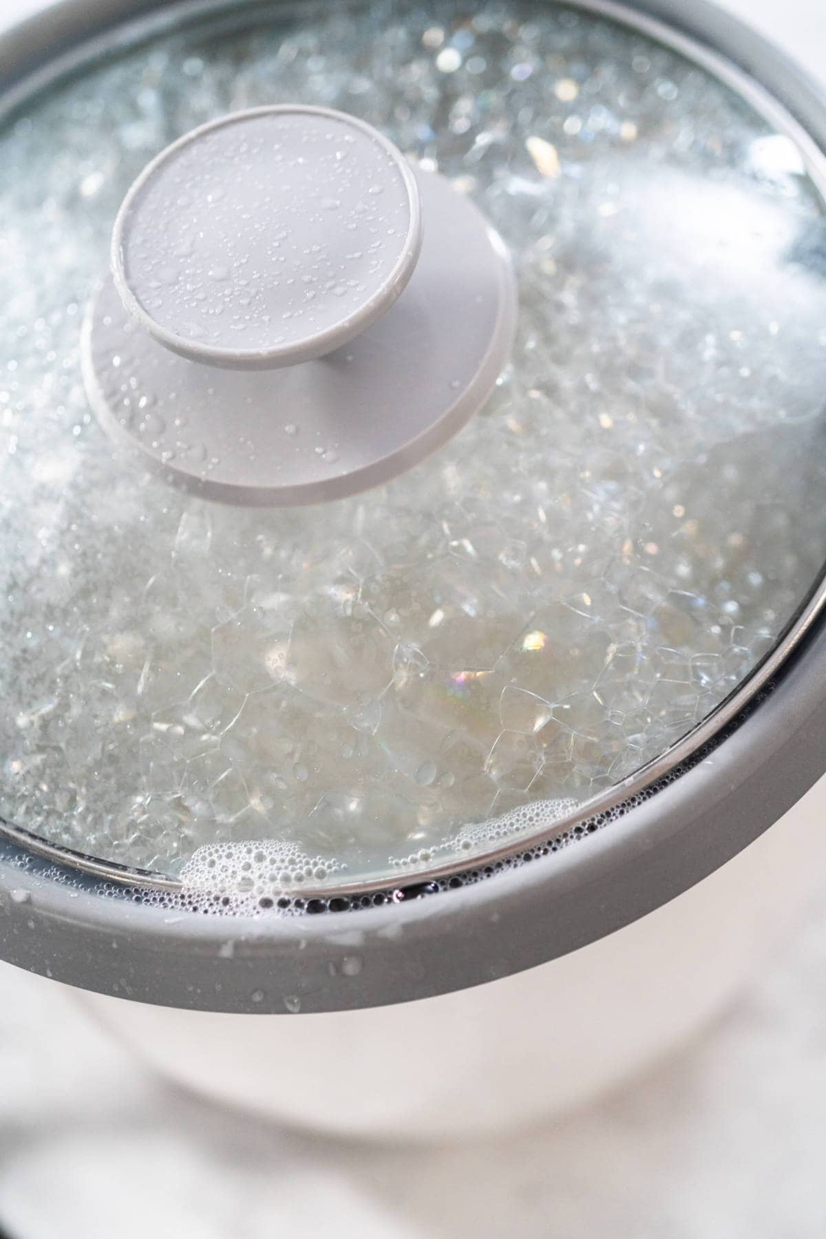 Long-grain white rice cooking in an electric rice cooker.