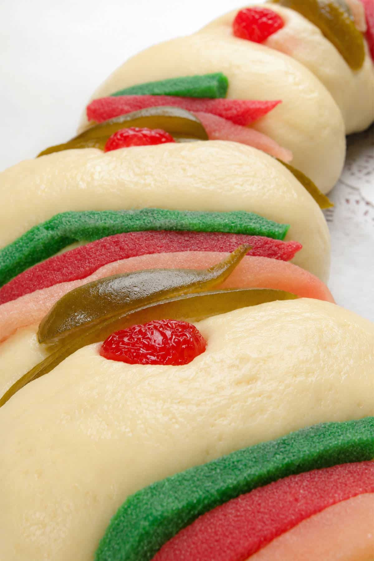 Unbaked Rosca de Reyes ephiphany cake with cookie paste and candied acitron substitute decorations.