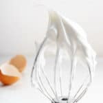 Whipped decorator royal icing on electric whisk.