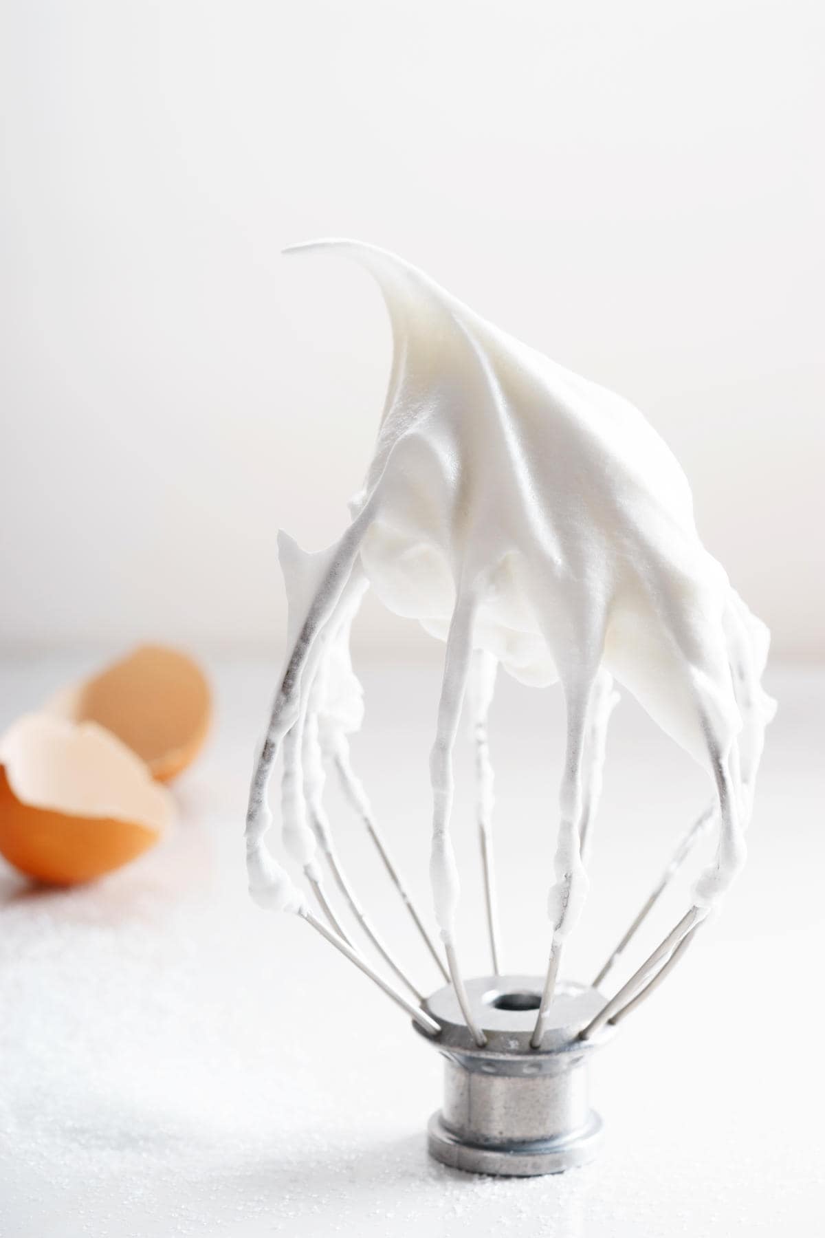 whipped royal decorating icing on a electric mixer whisk.