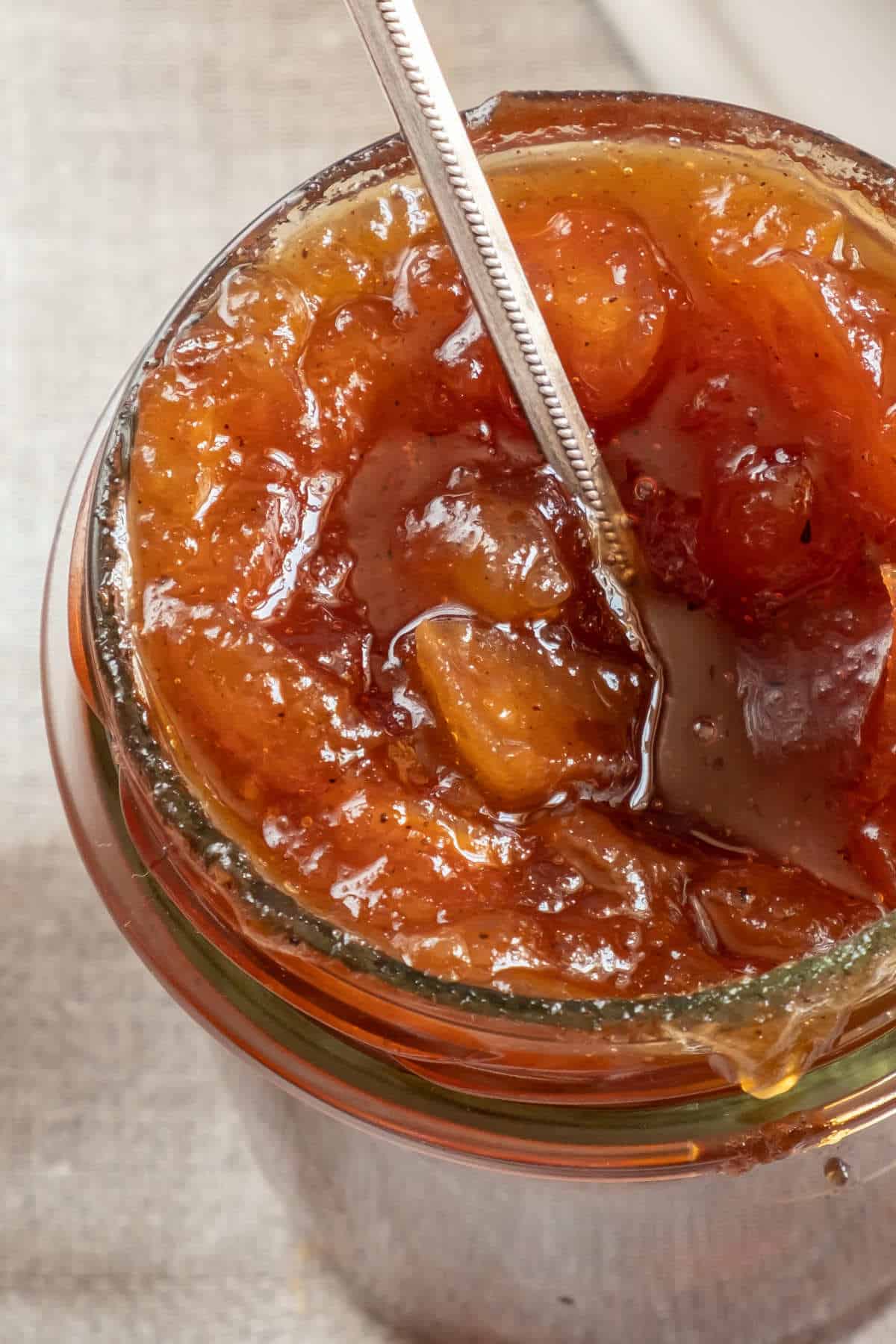 round canning jars of savory peach compote.