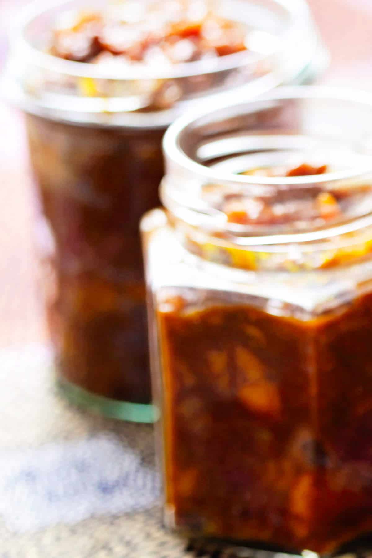 round canning jars of savory peach compote.