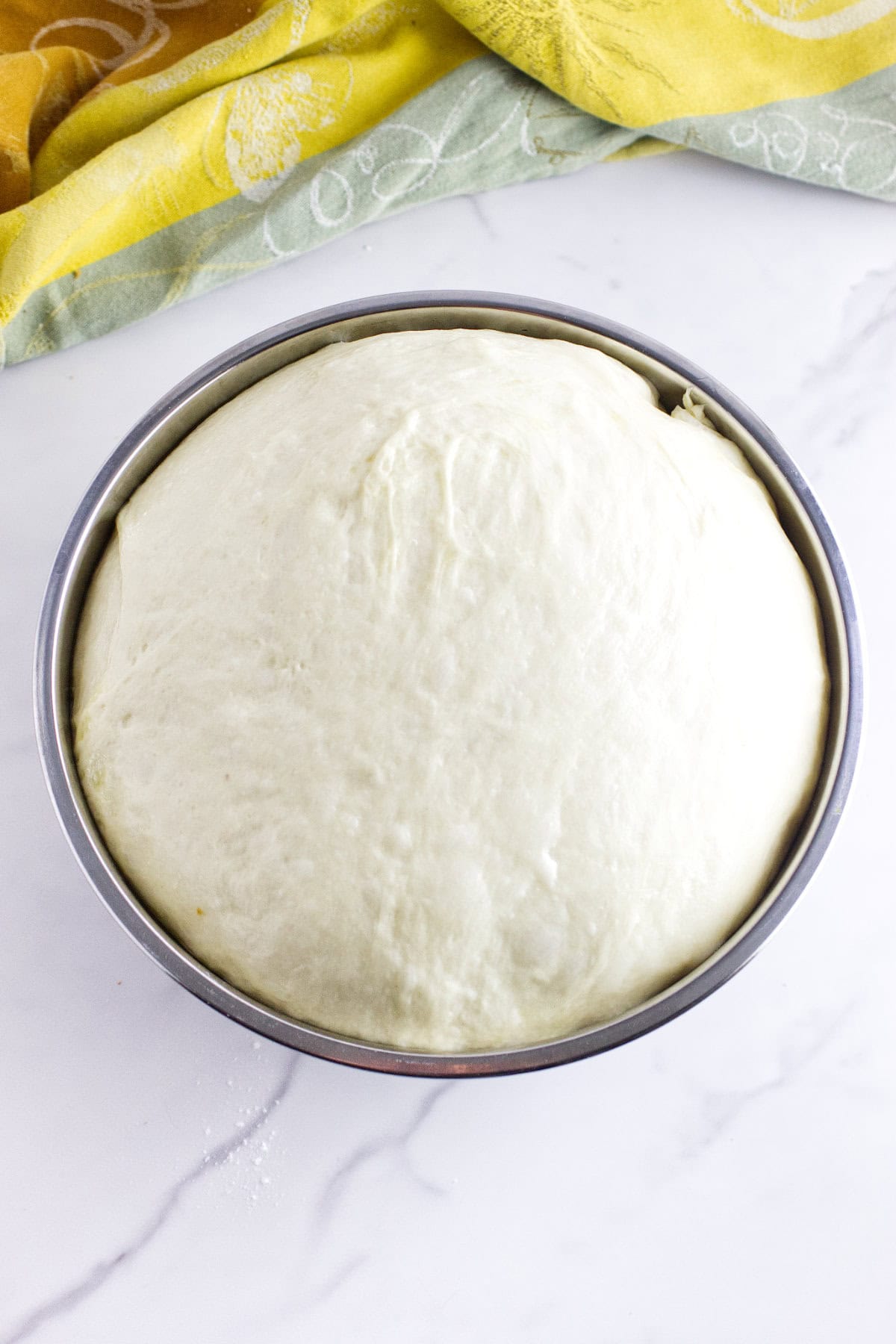 Dough covered and rising until doubled in size.